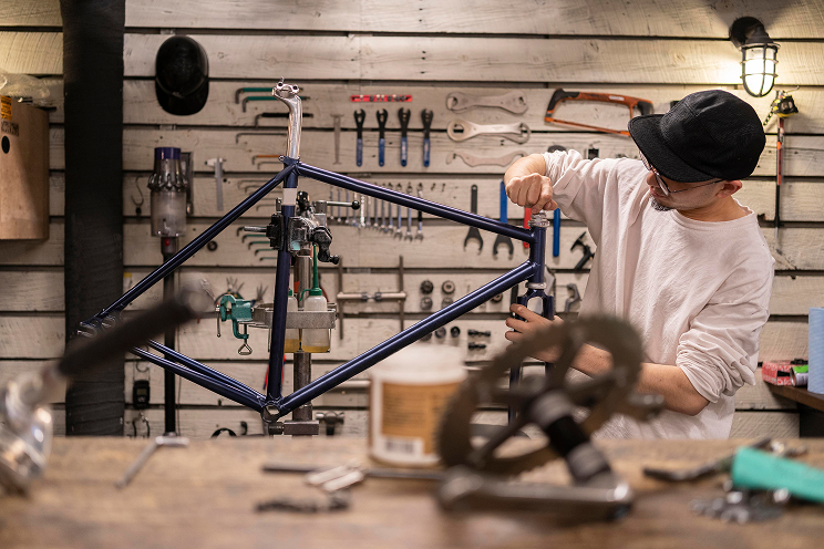 medium-shot-man-repairing-bike 1 Threat Alliance | Enterprise-Grade Cybersecurity Services for Growing Small Businesses